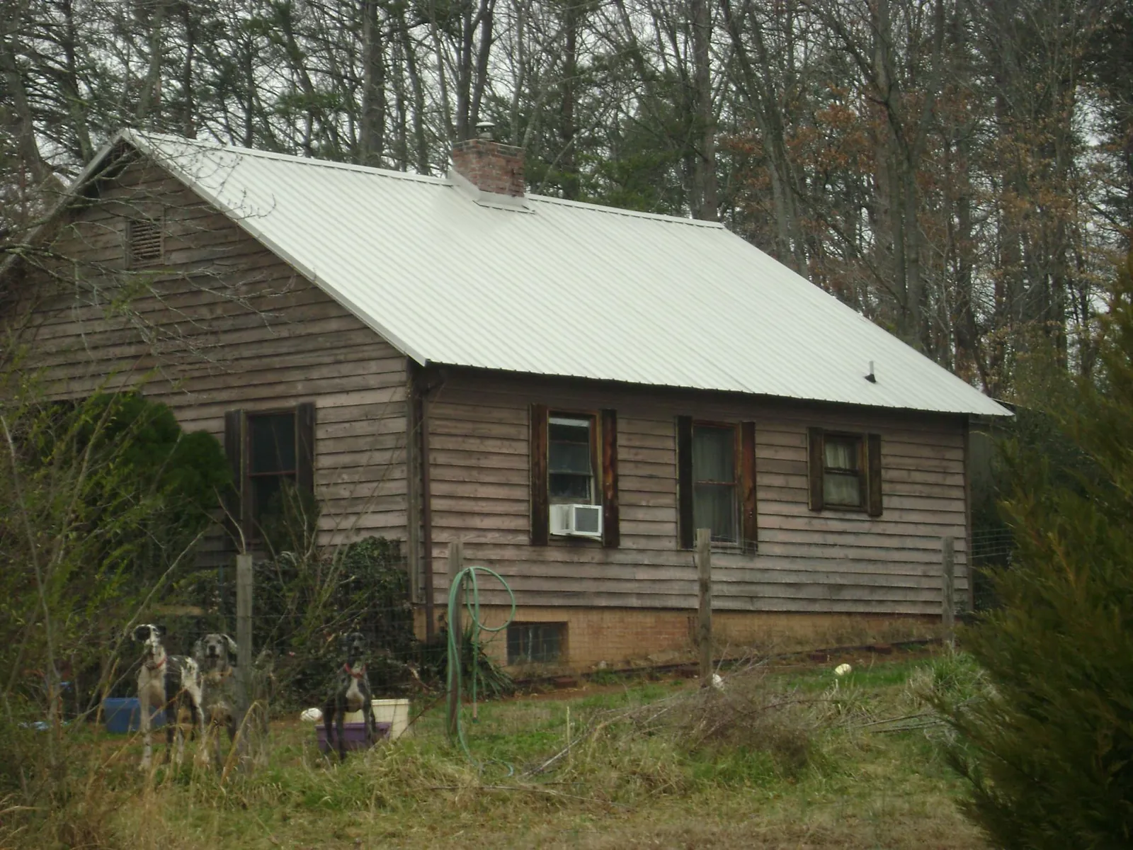 White metal roof on an old wood sided farmhouse, from a Metal Roof Installation job in Yemassee
